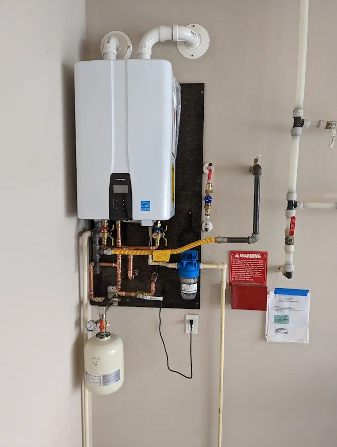 Professional plumber installing copper piping in a Batesville home